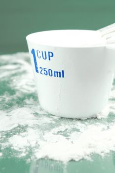 Measuring cups isolated against a green background