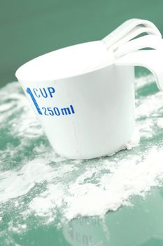 Measuring cups isolated against a green background