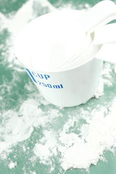 Measuring cups isolated against a green background