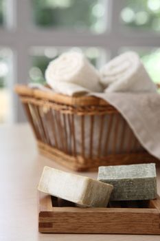 Soaps,towels and basket with a blurred background