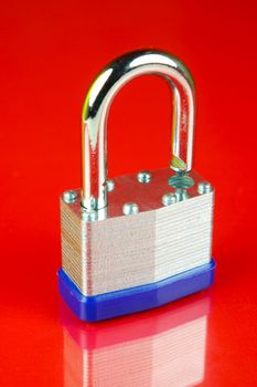 A padlock isolated against a red background