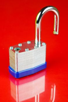 A padlock isolated against a red background