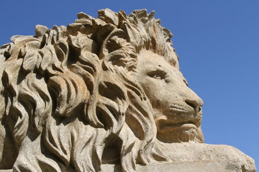 Casting of a lion against a blue sky.