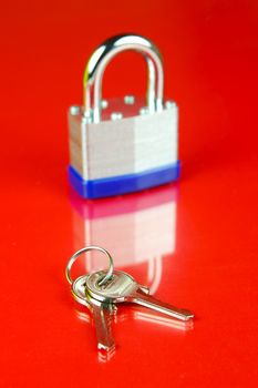 A padlock isolated against a red background