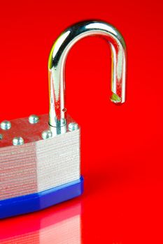 A padlock isolated against a red background