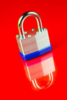 A padlock isolated against a red background