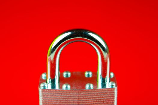 A padlock isolated against a red background