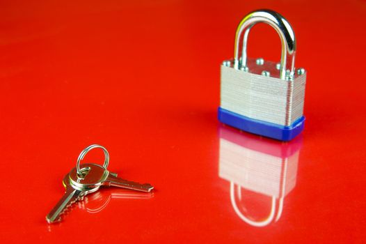 A padlock isolated against a red background