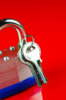 A padlock isolated against a red background