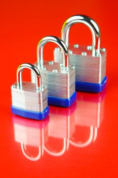 A padlock isolated against a red background