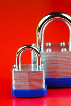 A padlock isolated against a red background