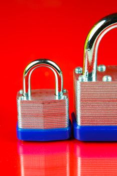 A padlock isolated against a red background