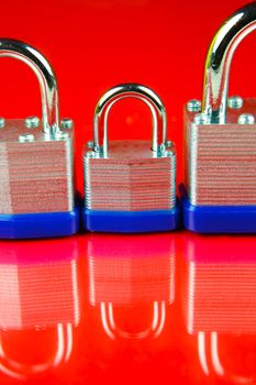 A padlock isolated against a red background