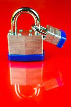 A padlock isolated against a red background