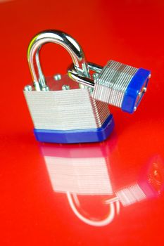 A padlock isolated against a red background