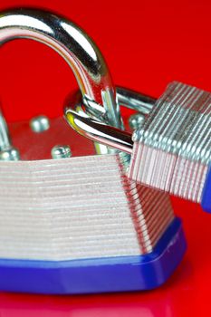 A padlock isolated against a red background