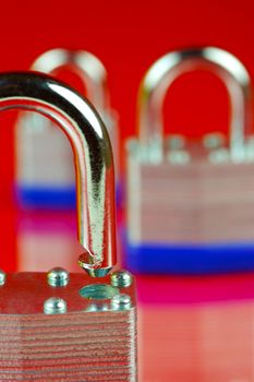 A padlock isolated against a red background