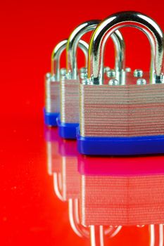 A padlock isolated against a red background