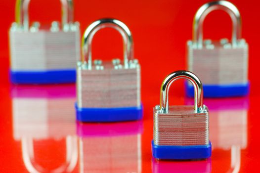 A padlock isolated against a red background