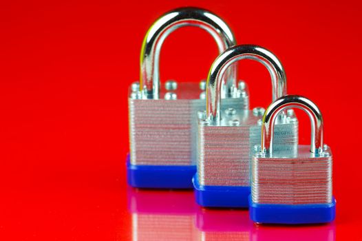 A padlock isolated against a red background