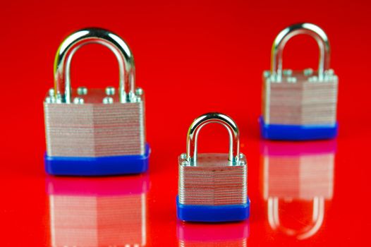 A padlock isolated against a red background