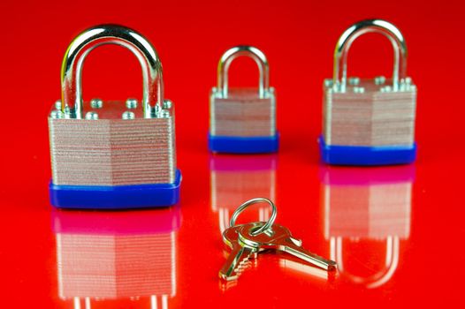 A padlock isolated against a red background