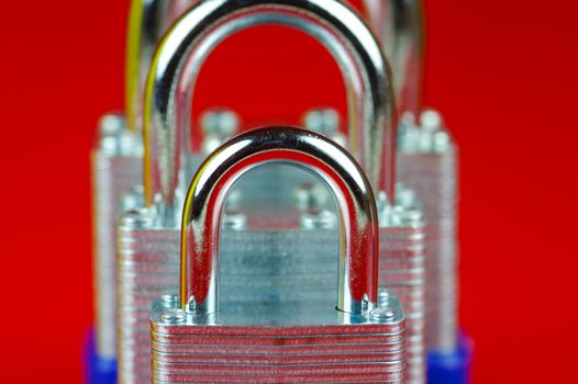 A padlock isolated against a red background