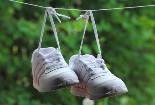 child shoes hanging on wire