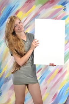 Beautiful blond woman, holding a blank paper for sign advertising 
