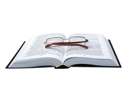 The opened book on which glasses lay, is isolated, on a white background