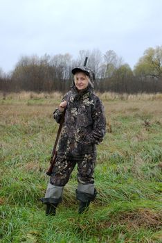 The girl dressed in a camouflage with a gun