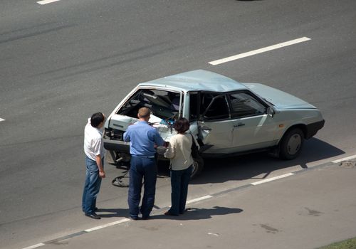 The man, the woman and the inspector of a traffic police near the broken car