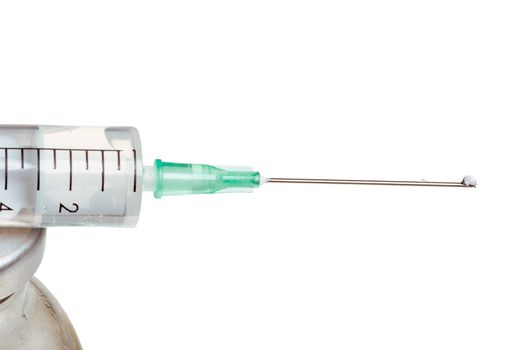 Drop on a tip of a needle of a syringe, it is isolated, on a white background.