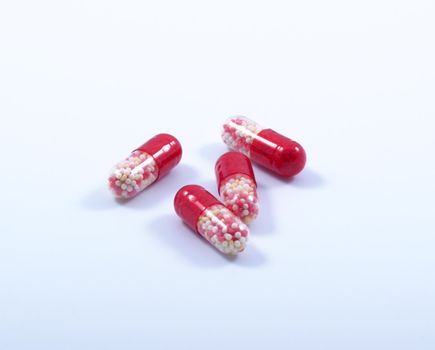 Multi-coloured capsules on a white background