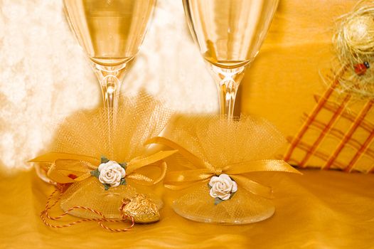 two glasses of champagne with golden holiday decoration