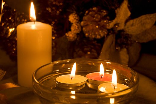 Candles with golden decoration on dark background