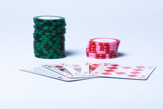 Piles of counters and Royal flush on a white background