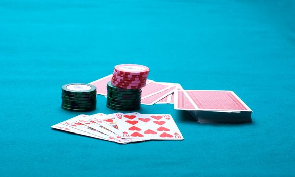 Piles of counters and a pack on green cloth