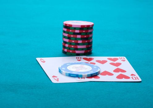 Piles of counters and a Black jack on green cloth