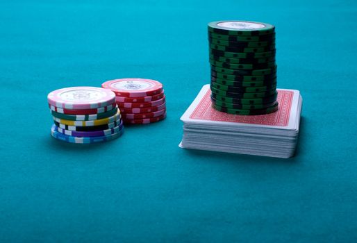 Piles of counters and a pack on green cloth