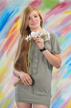 Portrait of long-haired beautiful girl 16-17 years with orchid