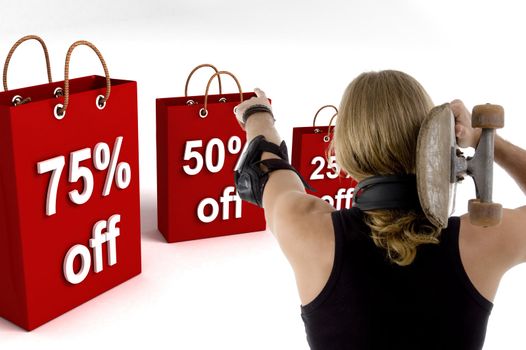 back pose of man pointing at shopping bags with skateboard 