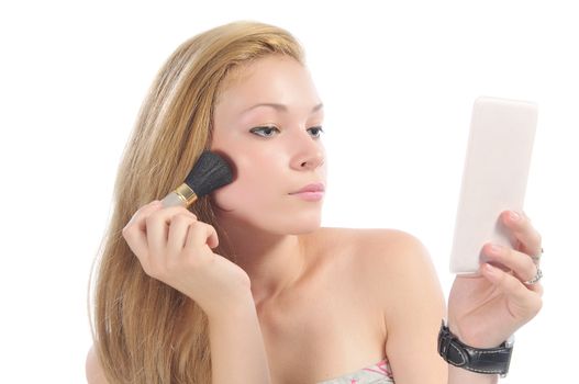 Long-hair blonde applying make-up, isolated on white.