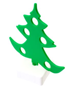 Toy plastic green tree on the white background