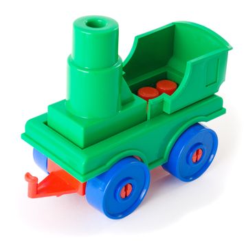 Toy green plastic engine on the white background