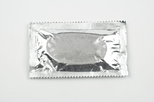 a single condom, isolated on white background