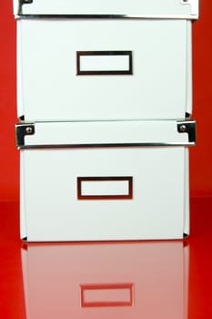 Storage boxes isolated against a red background