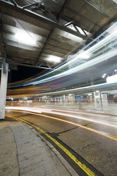 Bus speeding through night street. Hong Kong, China. 
