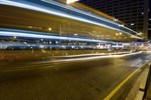Bus speeding through night street. Hong Kong, China. 
