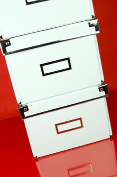 Storage boxes isolated against a red background